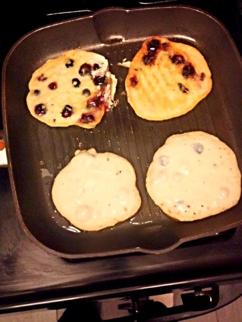 gluten-free berry cake pancakes cooking on the griddle